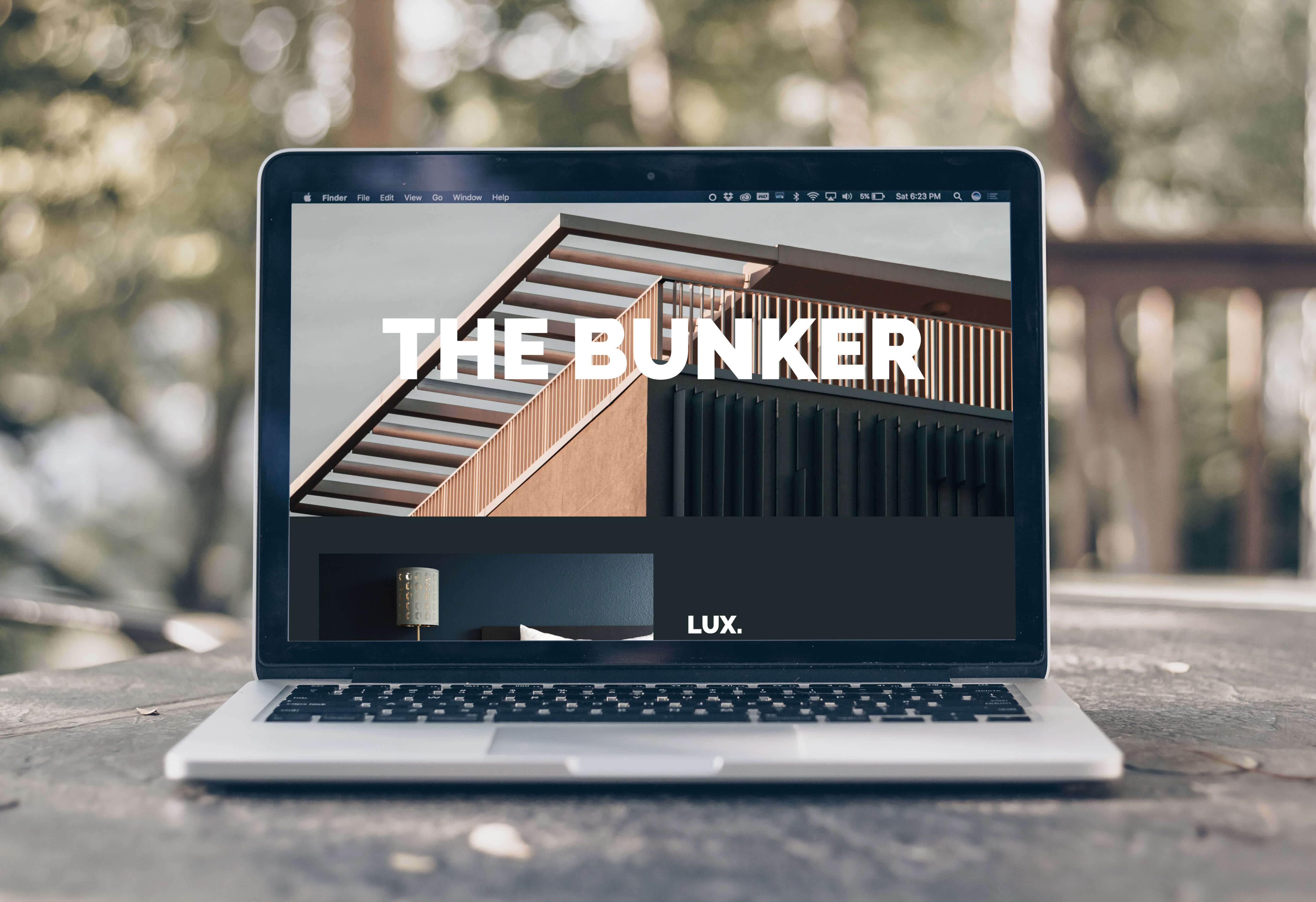 Laptop displaying The Bunker Hotel website homepage.